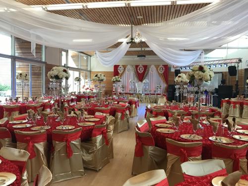 A ballroom highly decorated in red and gold for a formal event.