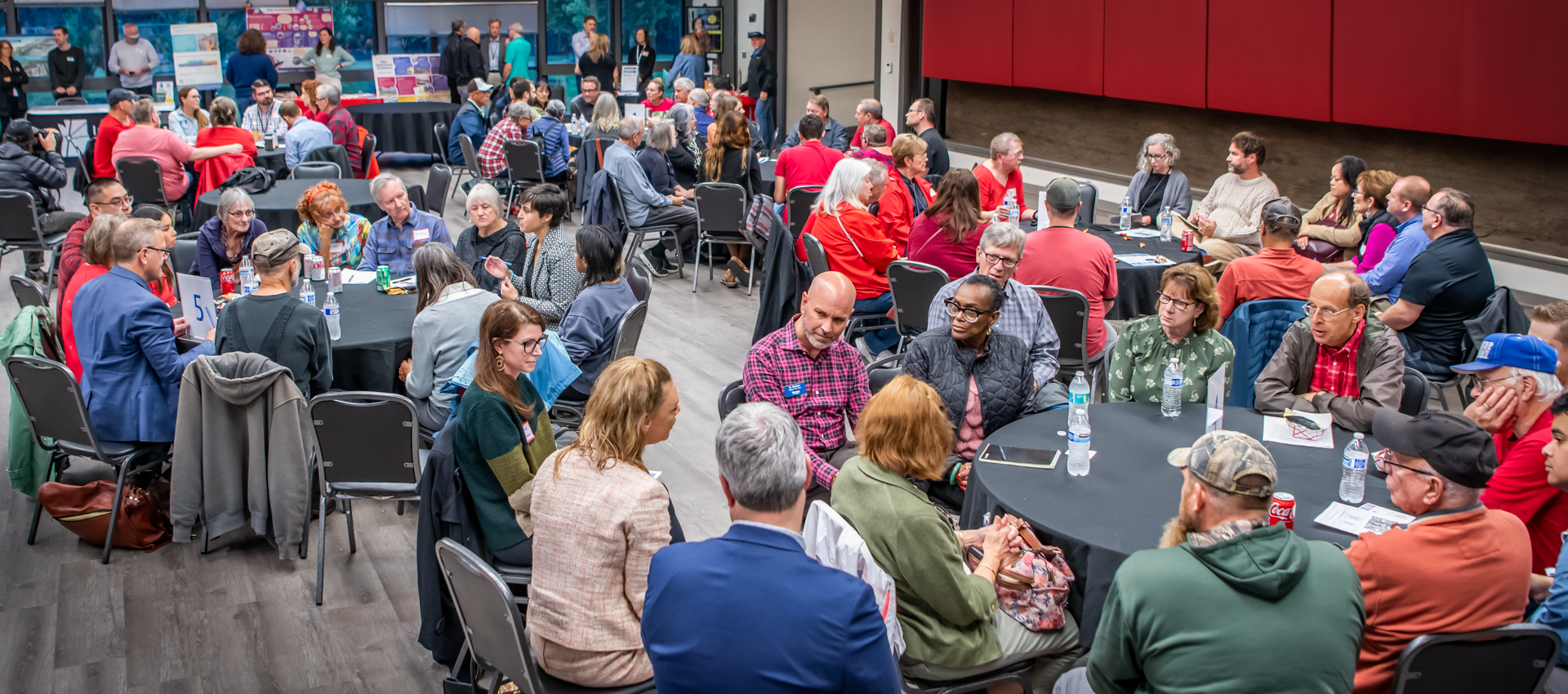 An image of community members and councilors in small-group conversations, during a previous Council Community Forum at the Luepke Center.