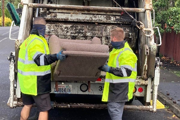 Waste Connections workers pick up a bulky item