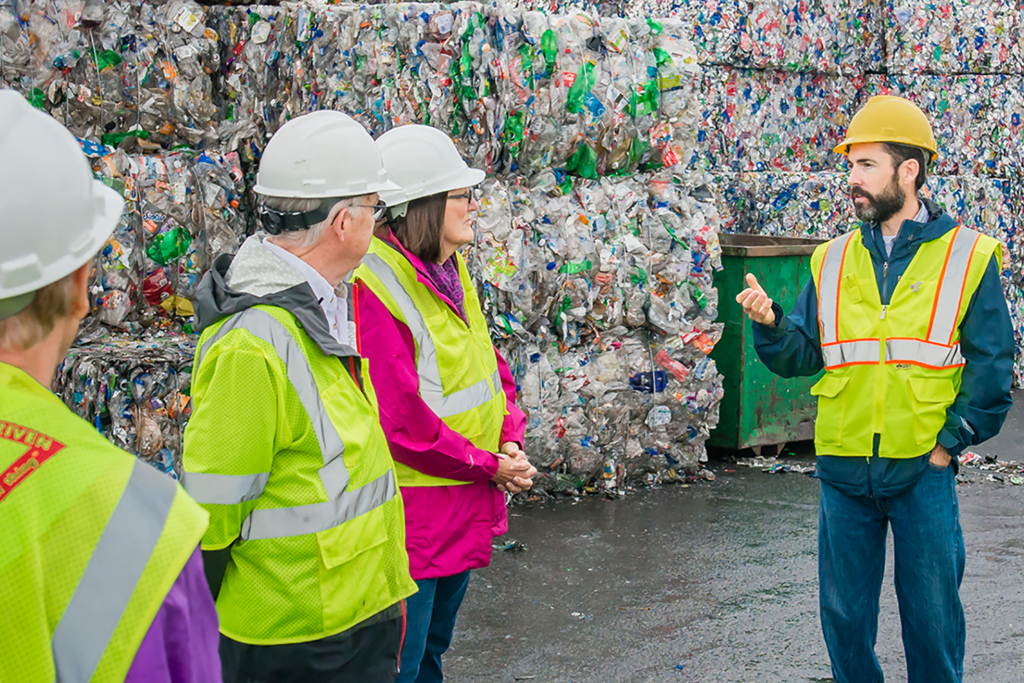 Community members taking a tour or local material recovery facility.