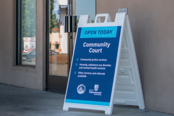 Community court sign in front of the entrance to new court location