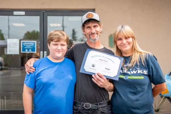 Community court graduate celebrating with his family