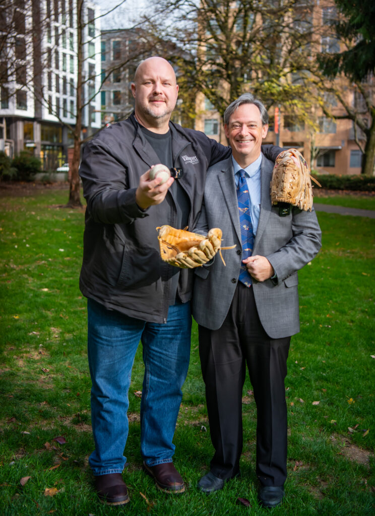 Code enforcement officer John Scukanec and City Manager Lon Pluckhahn pose for a photo after playing John's 1,000th consecutive daily game of catch