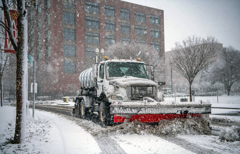 snow plow removing snow from city streets