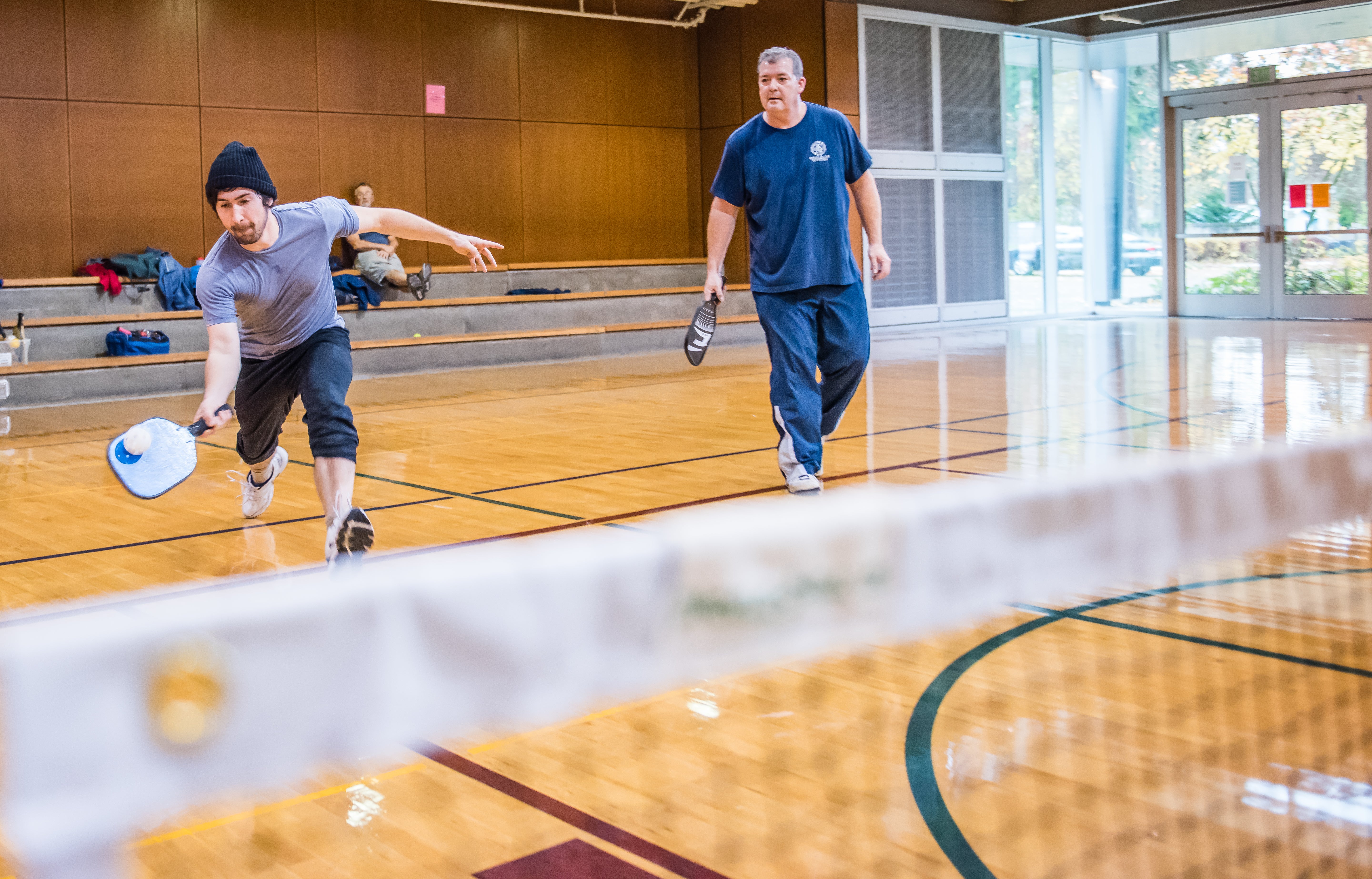 Adults playing pickleball in the Firstenburg gymnasium