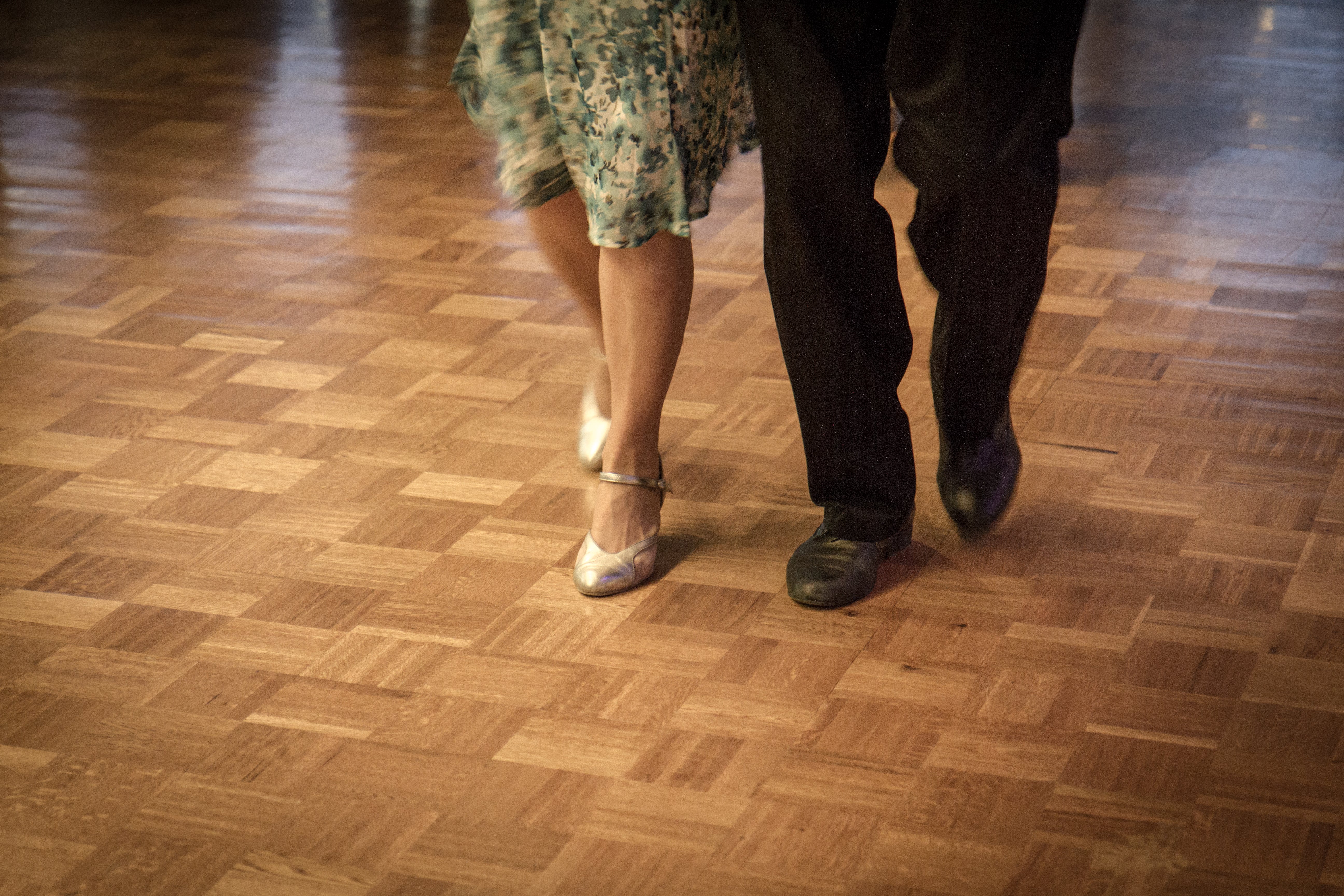 Close-up on well-dressed couple's dancing shoes